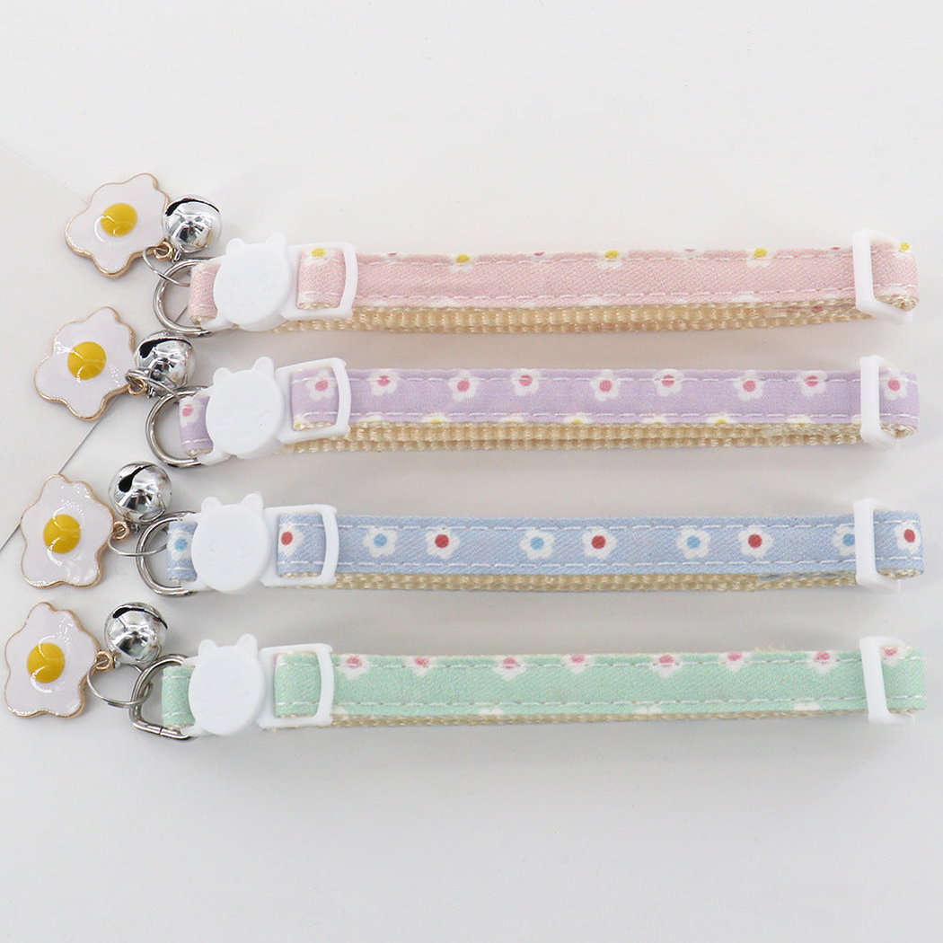 Four pastel pet collars with cat-shaped sliders, bells, and flower charms