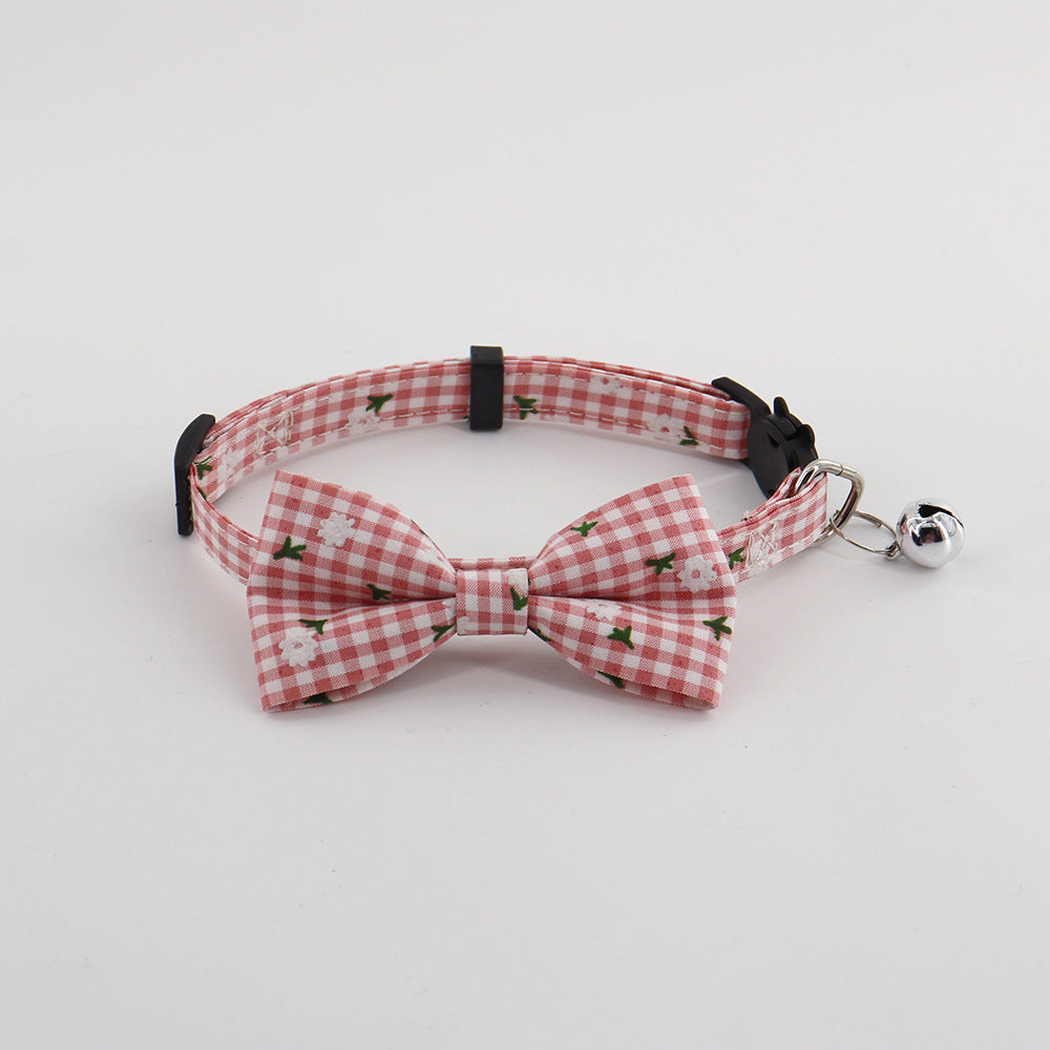 Pink gingham pet collar with bow and bell, front view