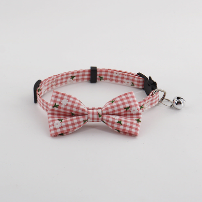 Pink gingham pet collar with bow and bell, front view