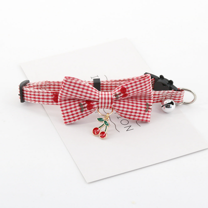 Red gingham pet collar with bow, bell, and hanging cherry charm
