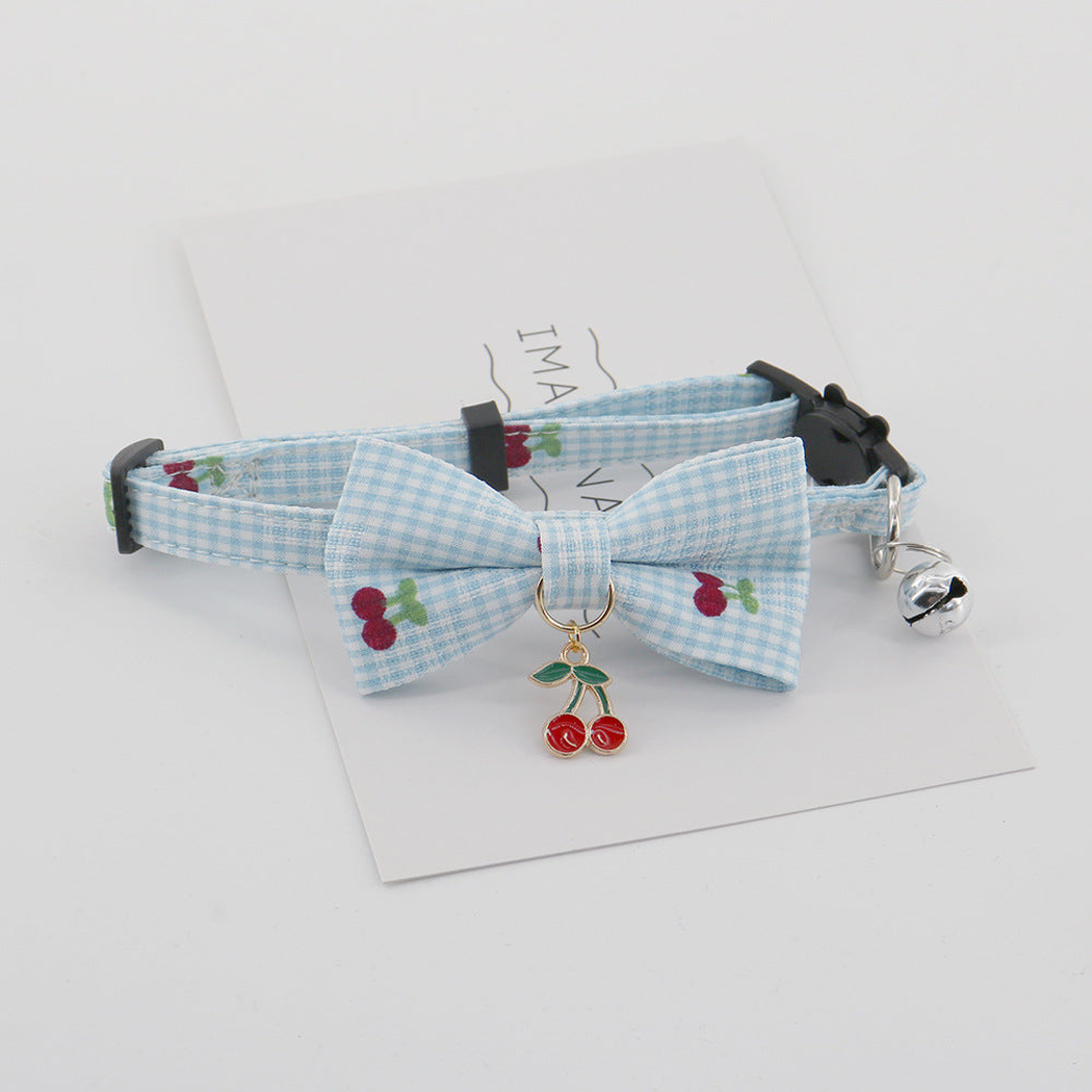 Light blue gingham pet collar with bow, bell, and hanging cherry charm