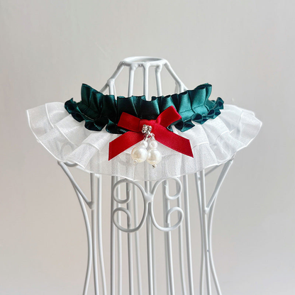 Deep teal layered ruffled pet neckwear with a contrasting bow and dangling bead accents