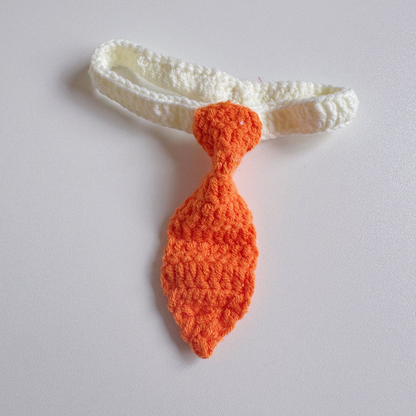 Orange tie-shaped pet neckwear with a white looped strap