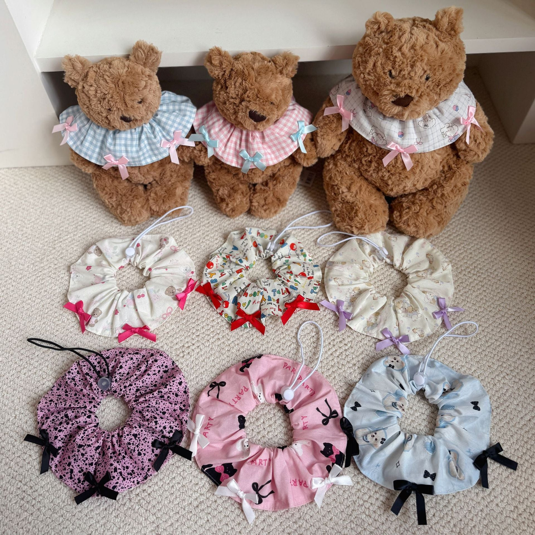 Multiple patterned pet neckwear styles shown with teddy bears and arranged below