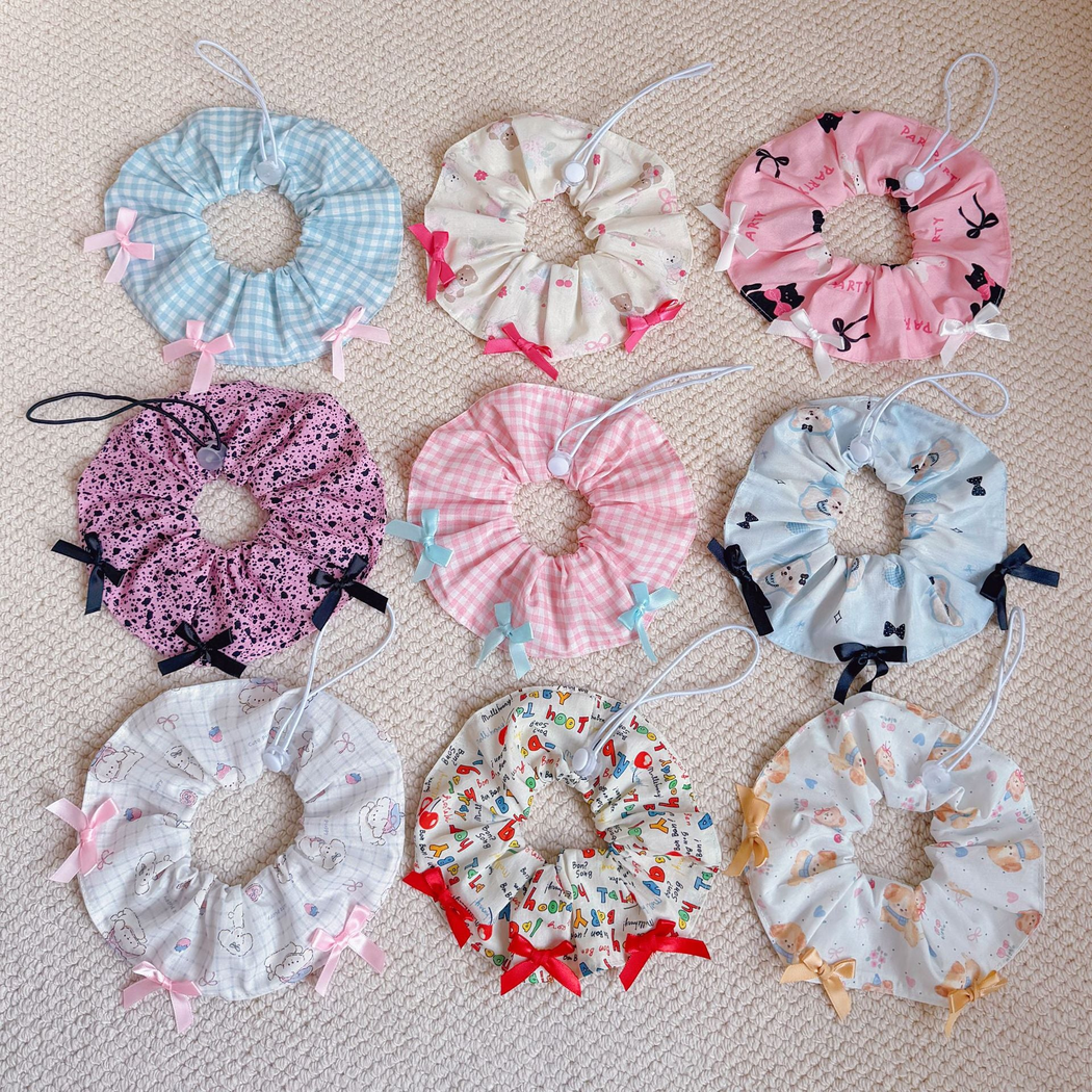 Multiple patterned pet neckwear pieces arranged on a carpet