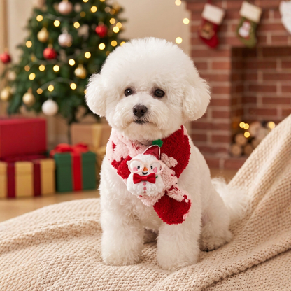 White dog wearing red and pink fuzzy pet neckwear with a snowman decoration