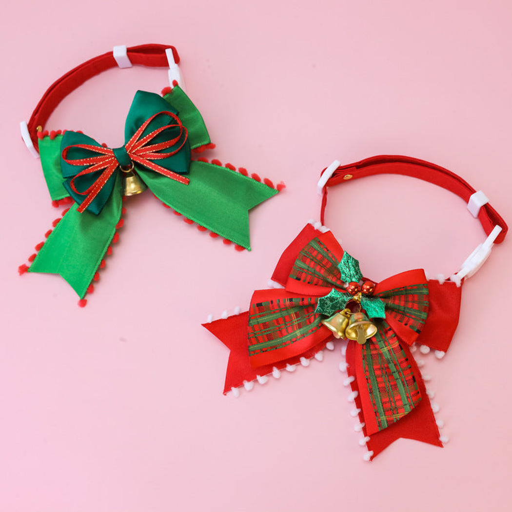 Red and green pet collars with large bows displayed together