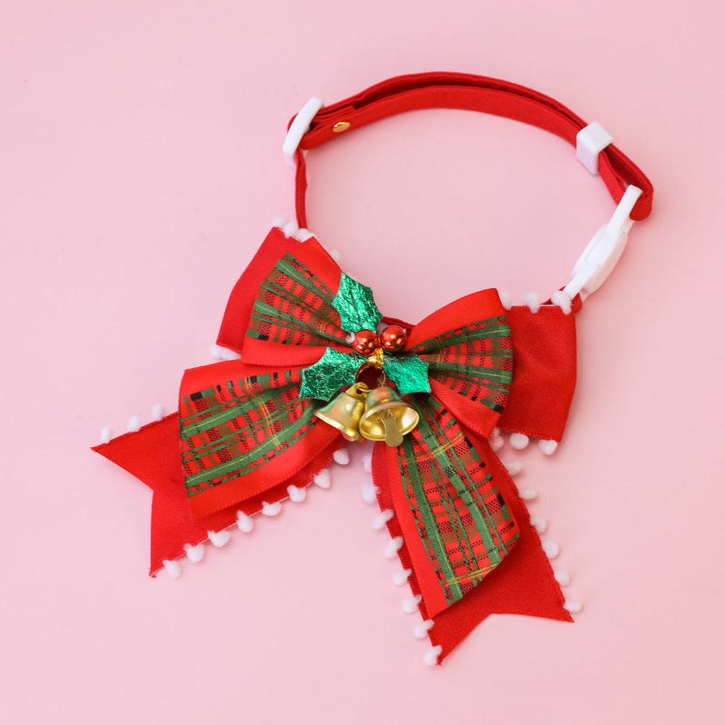 Plaid Bow pet collar with a red-and-green plaid bow on a pink background