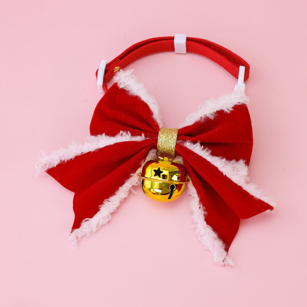 Bow+Gold pet collar with red bow, white buckle, and hanging gold-tone bell