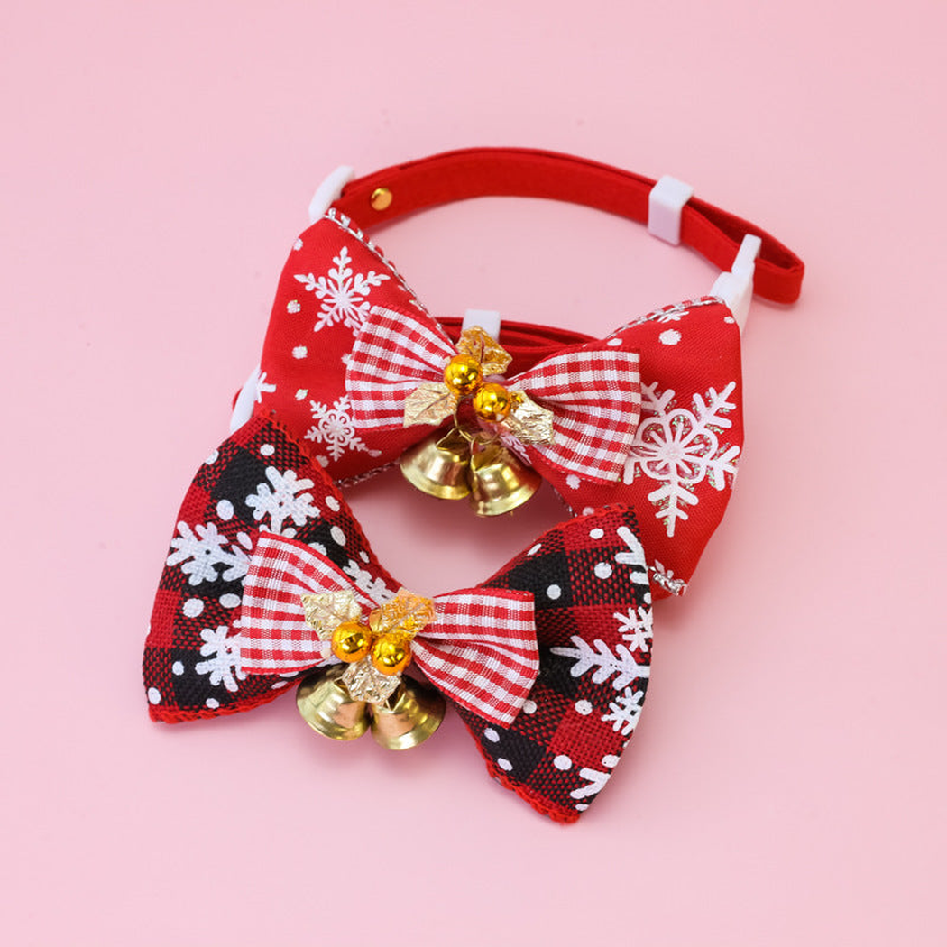 Red Plaid and Black Snowflake pet collars with bows and bells displayed together