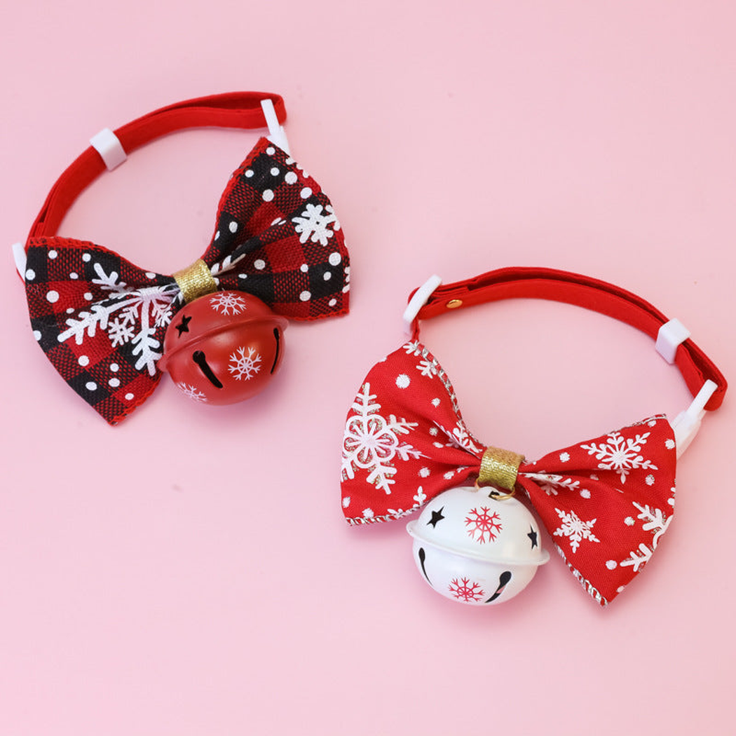 Red Snowflake and Black Snowflake pet collars with bows and bells displayed together