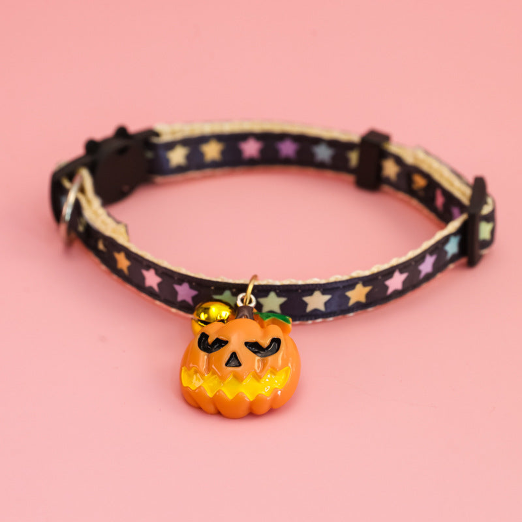 Pumpkin Style pet collar with multicolored stars, a bell, and jack-o'-lantern charm