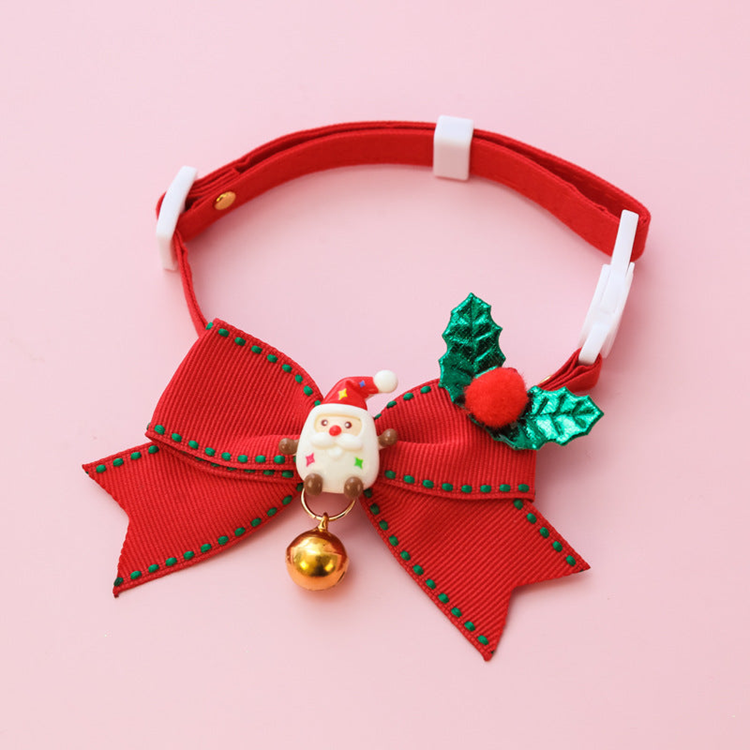 Santa style red pet collar with a large bow, holly accents, and hanging bell