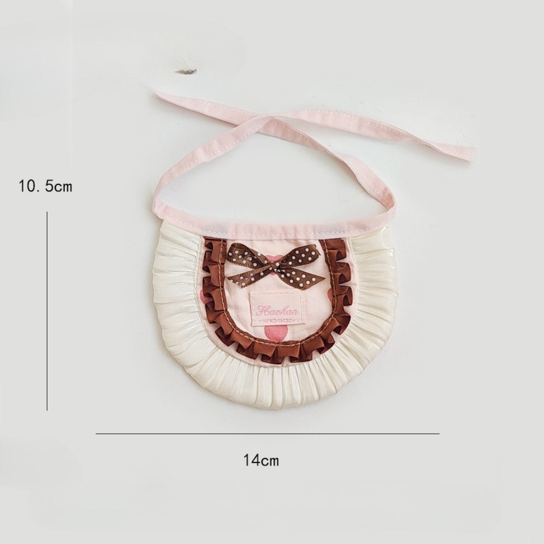 Side view of Mokka cat wearing the polka dot bow bib