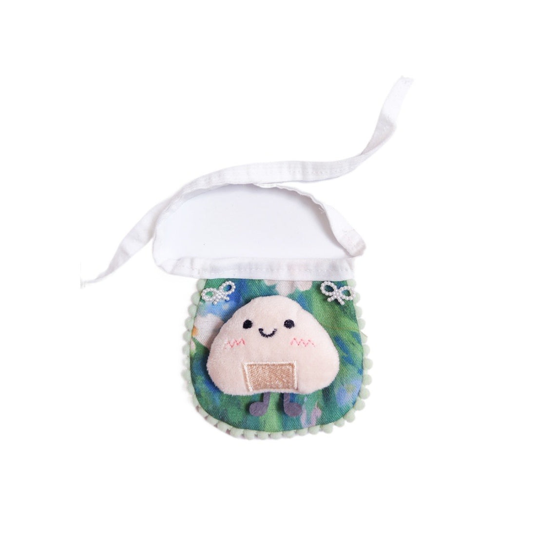 Mokka cat bib next to baby feeding accessories on a wooden surface