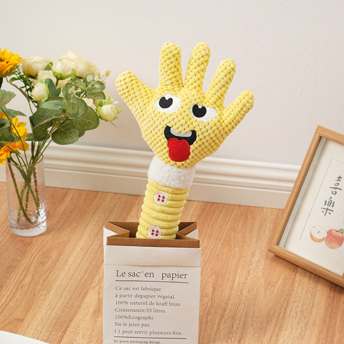 Petkin plush dog toy with squeaker being squeezed to demonstrate sound feature