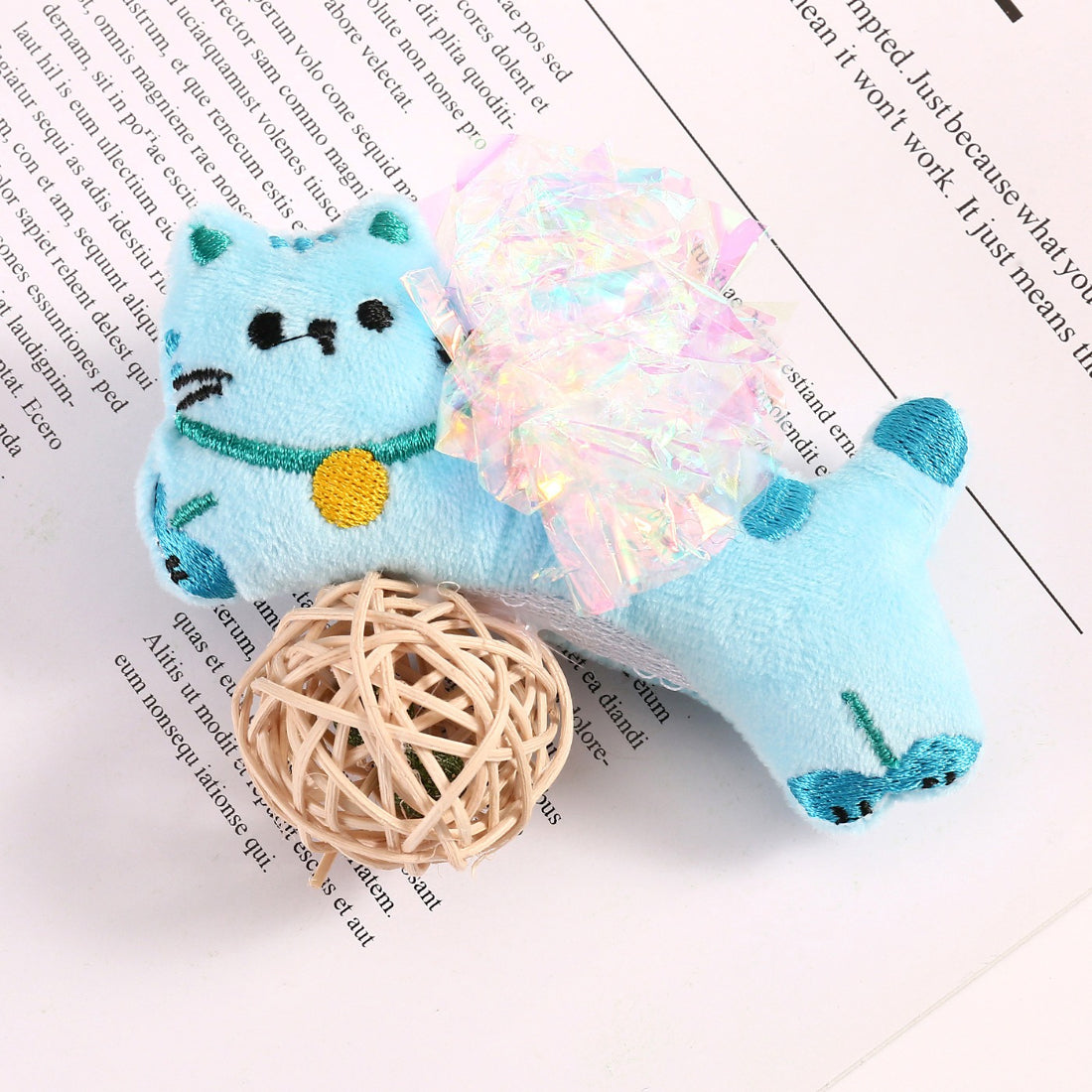 Moo cat toy being held to demonstrate size and soft plush design