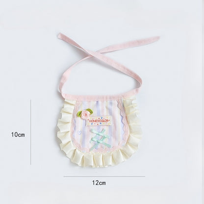Pastel apron bib worn by a child, highlighting fit and coverage