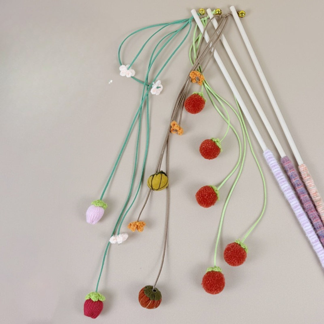 Moo Fruit Wand cat toy with orange pom pom teaser on wooden stick