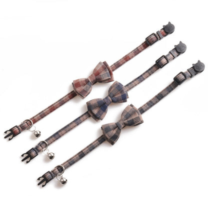 Close-up of Mokka plaid bow tie cat collar with small bell attached