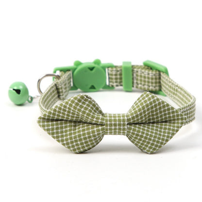Mokka gingham bow tie cat collar with bell hanging on a hook