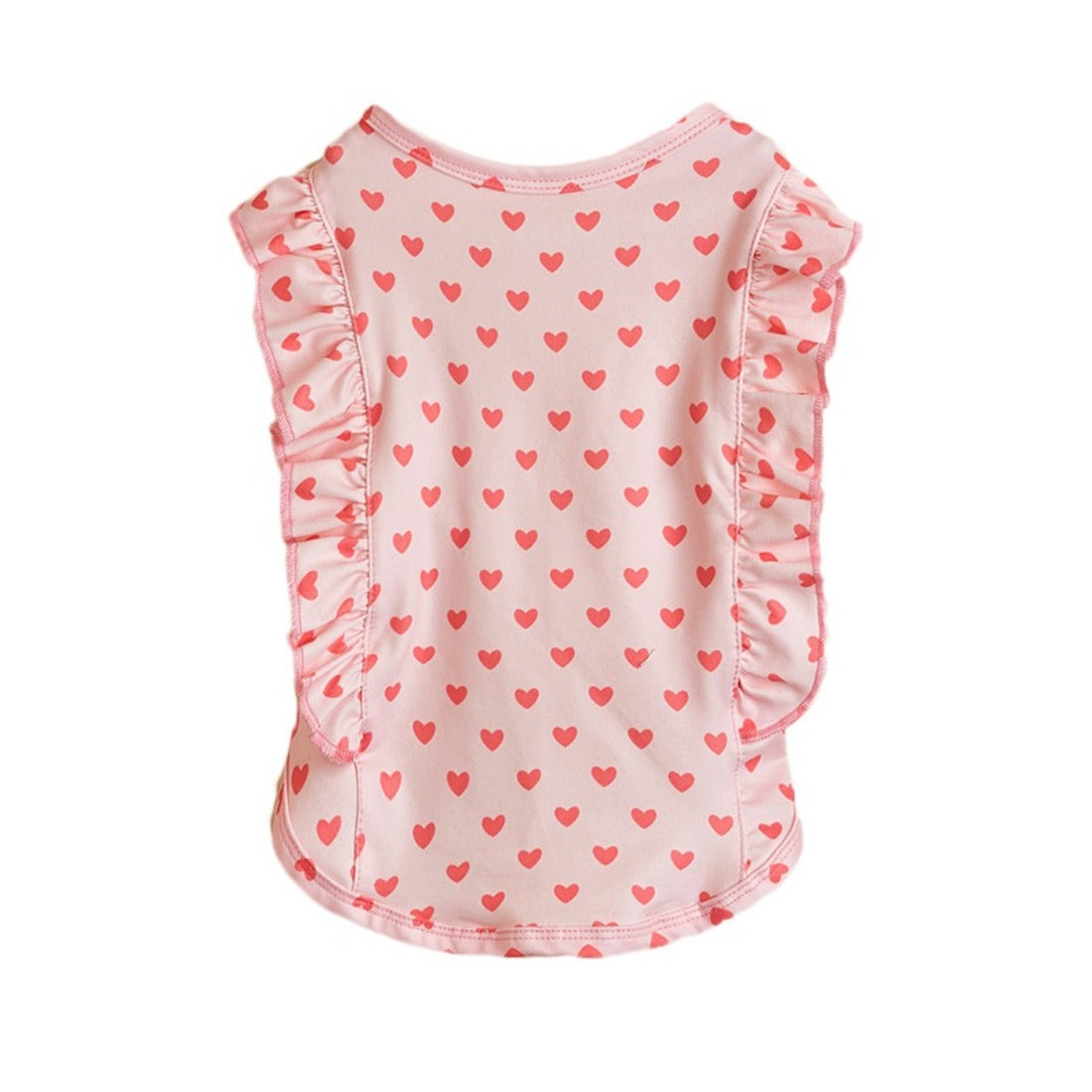 Ozzie dog standing outdoors on grass wearing heart print ruffle t-shirt