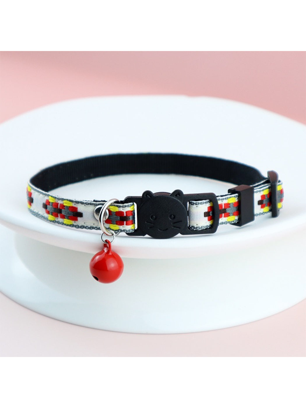 Mokka colorful woven cat collar on a wooden surface highlighting fabric texture