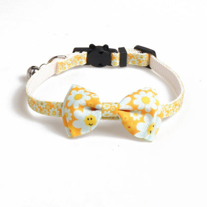 Mokka floral bow tie cat collar with bell photographed on dark surface