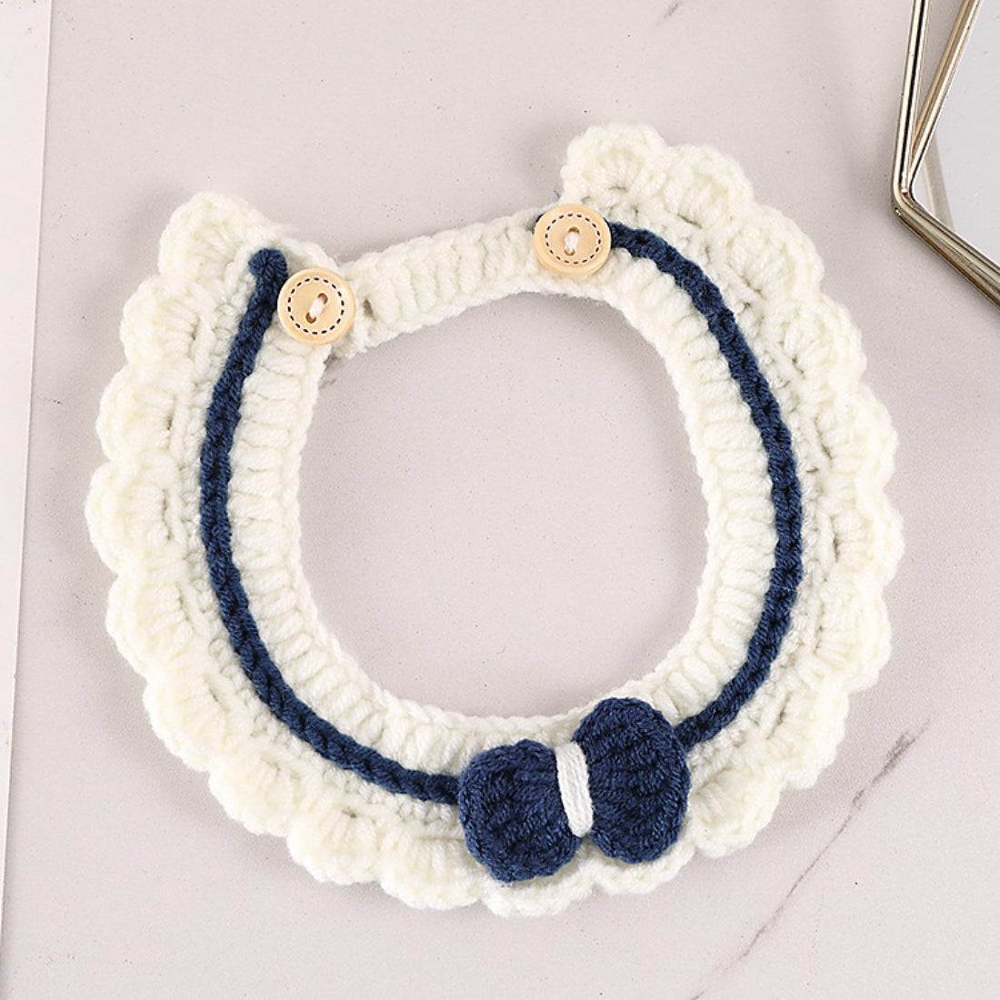Mokka crochet cat collar with button and bell on a white background
