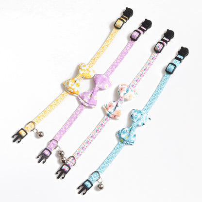 Close-up of Mokka floral bow tie cat collar showing bell detail