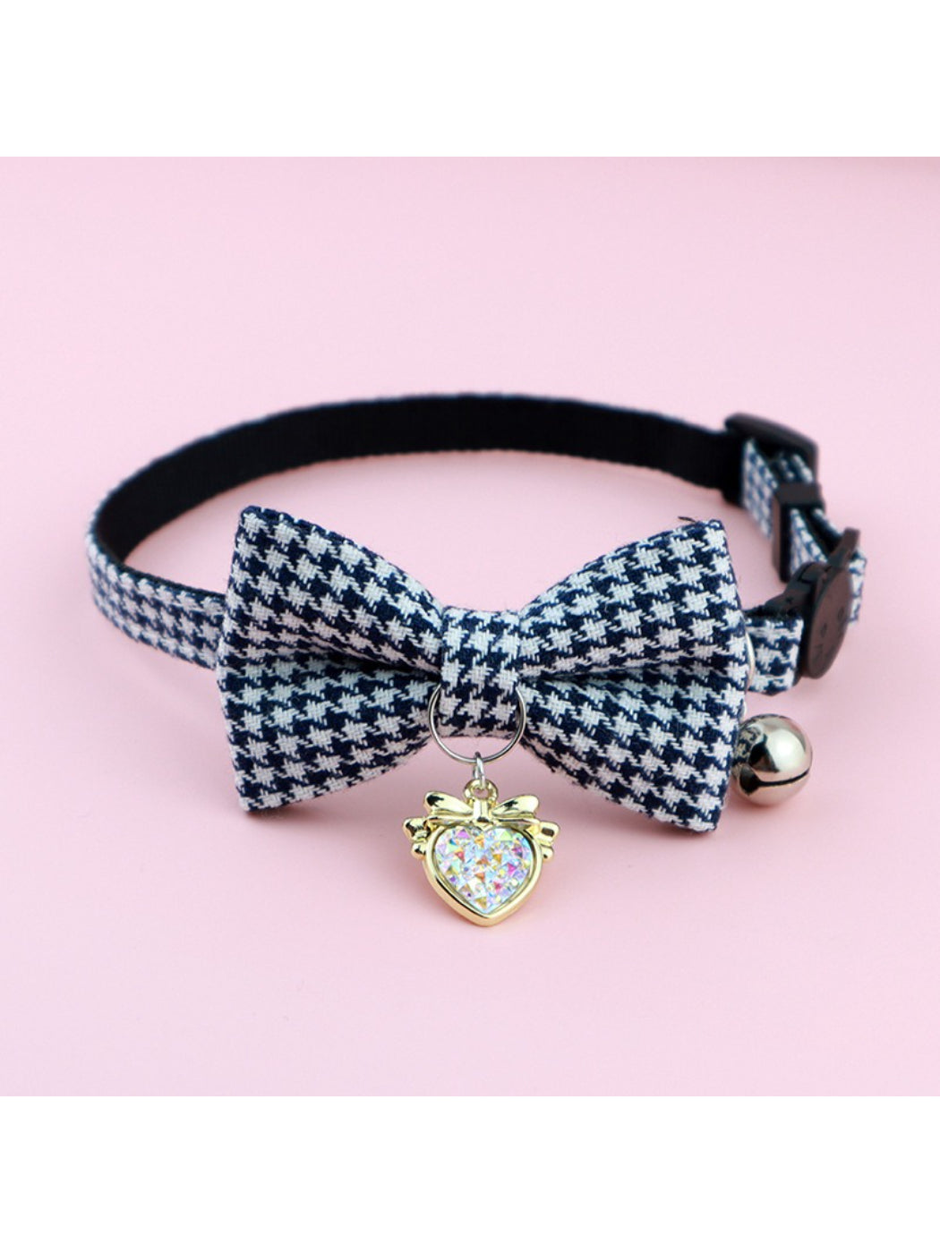 Mokka cat collar with black and white bow and bell on a light background