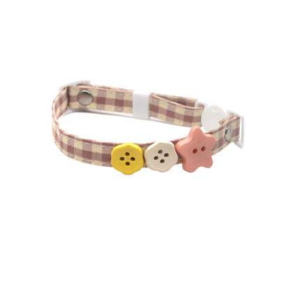Pink breakaway cat collar with Mokka button charm displayed flat