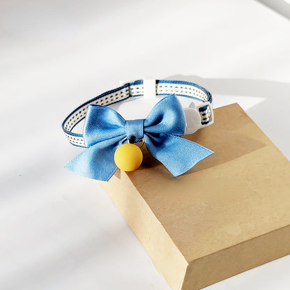 Close-up of Mokka cat collar showing bowknot and small bell detail
