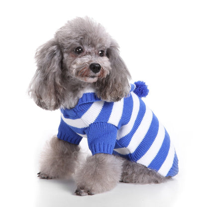 Small dog modeling Ozzie soft pajamas and hat indoors
