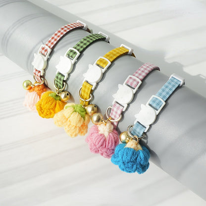 Mokka cat collar featuring grid pattern and strap on white surface