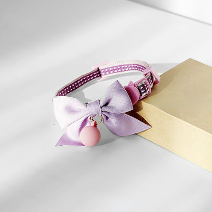 Mokka cat collar with bowknot and bell laid flat to show strap