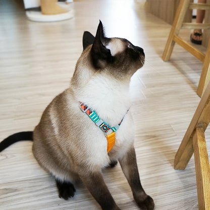 Cat resting while wearing Loofie cat harness