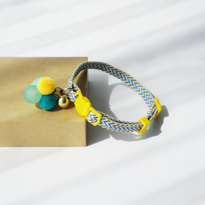 Mokka cat collar coiled to show break-away buckle, D-ring and bell