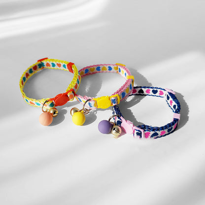 Mokka Valentine themed cat collar shown coiled with heart decorations